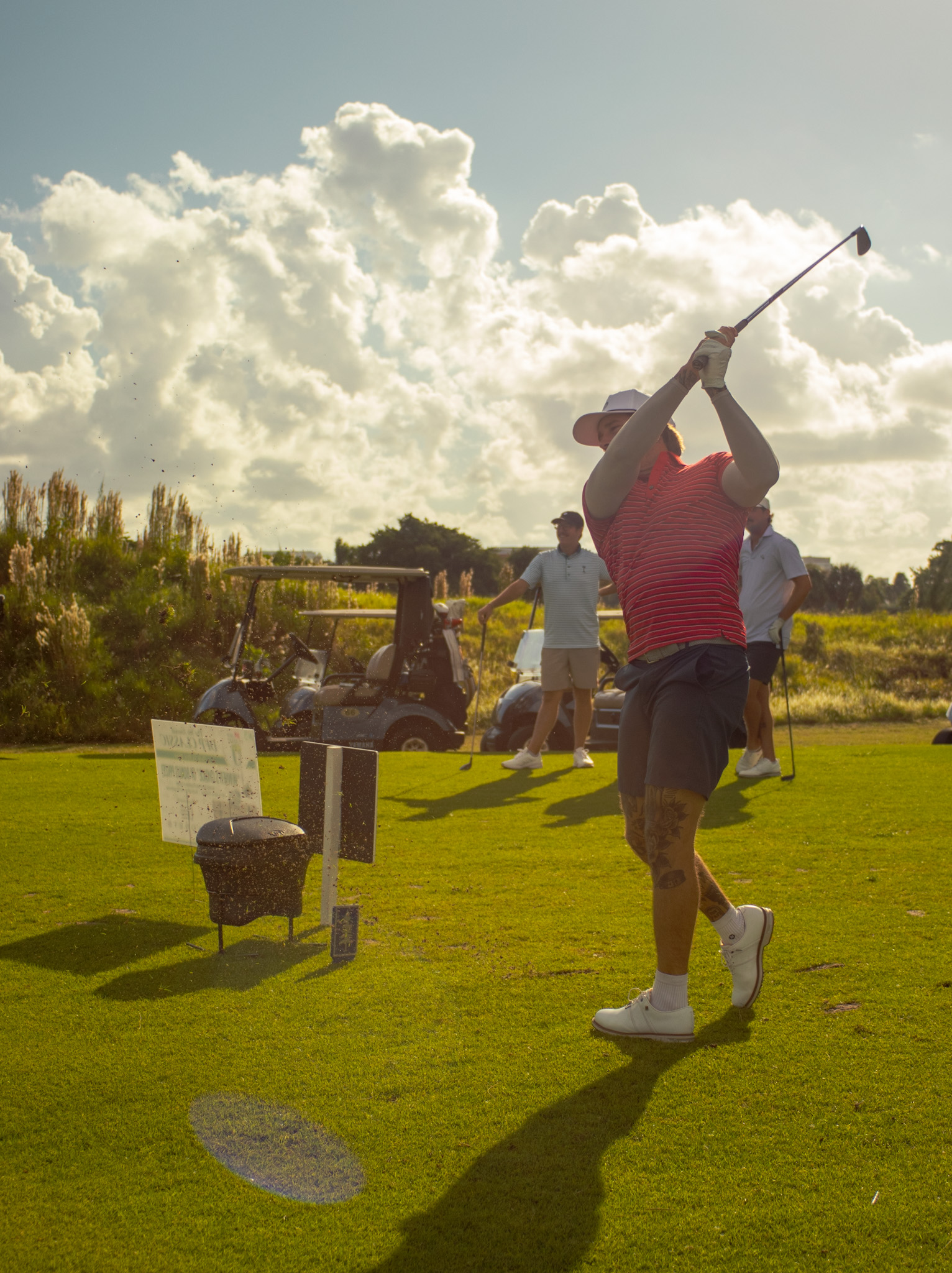 Golfer following through at golden hour during the DFP Classic